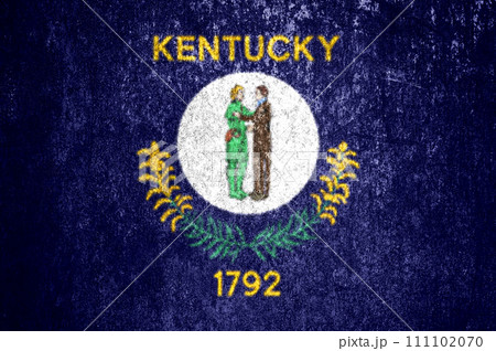 Close-up of the Kentucky grunge state flag. Dirty Kentucky state flag on a metal surface. Close-up of the Kentucky grunge state flag. Dirty Kentucky state flag on a metal surface. 111102070