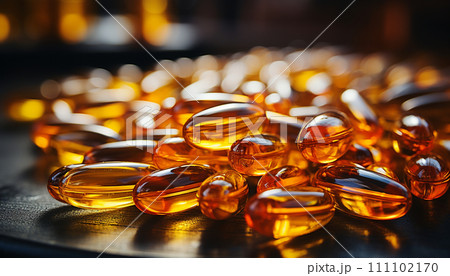 Close-up of golden Omega-3 fish oil capsules with reflections, illustrating the concept of natural health supplements. Close-up of golden Omega-3 fish oil capsules with reflections, illustrating the concept of natural health supplements. 111102170