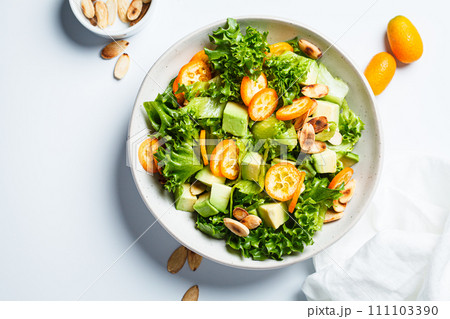 Kumquat salad with avocado and nuts. Kumquat salad with avocado and nuts. 111103390