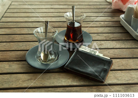 A forgotten wallet in a cafe, a wallet with money accidentally left on the table 111103613