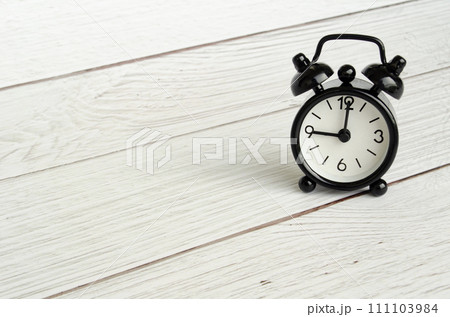 Black table alarm clock with customizable space for text. Time concept and copy space 111103984