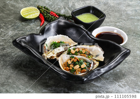Open half oysters with green onion Open half oysters with green onion 111105598