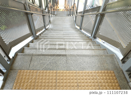 Empty staircase at a metro station. Public staircase with cleanly steel handrail. 111107238
