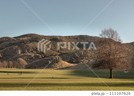 The breathtaking scenic landscape of Holyrood park with Salisbury Crags rugged hills and sky background. The breathtaking scenic landscape of Holyrood park with Salisbury Crags rugged hills and sky background. 111107626