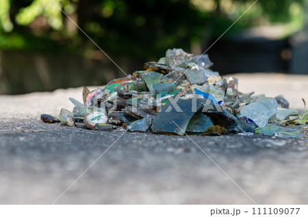 Pile of broken glass on the road. Small pieces of glass. Broken bottles on the nature. Pile of broken glass on the road. Small pieces of glass. Broken bottles on the nature. 111109077