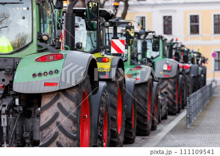 Farmers union protest strike against government Policy in Germany Europe. Tractors vehicles blocks city road traffic. Agriculture farm machines Magdeburg central Domplatz square 111109541