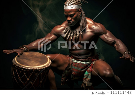 African drummer in traditional clothing playing a djembe drum and dancing against dark background. The man beats out a groovy rhythm. A brilliant performance by a musician. For music-related content 111111448