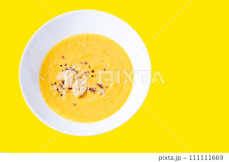 pumpkin cream soup with sesame seeds on a bright background. Yellow soup on a yellow background. 111111669