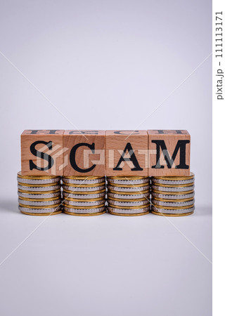 The inscription Scam made of wooden cubes on a plain background The inscription Scam made of wooden cubes on a plain background 111113171