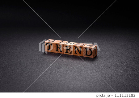 The inscription Trend made of wooden cubes on a plain background 111113182