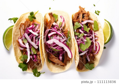 Top view of mexican pork carnitas tacos with greens and purple coleslaw isolated on white background 111113836