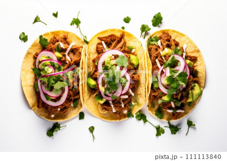 Top view of mexican pork carnitas tacos with greens, avocado and onion isolated on white background 111113840