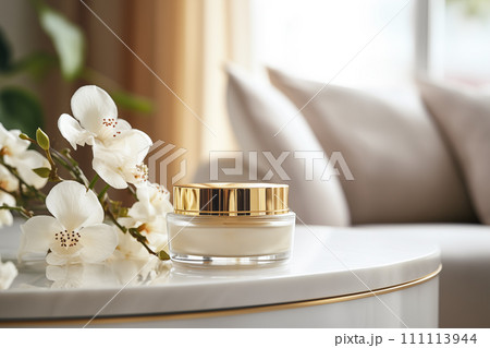 A jar of luxury cream with a golden lid in modern style on a white marble table with copy space 111113944