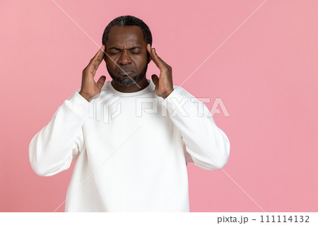 Unhealthy black man wearing white sweatshirt suffering headache 111114132