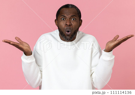 Surprised black man wearing white sweatshirt shrugging shoulders Surprised black man wearing white sweatshirt shrugging shoulders 111114136