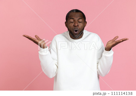 Shocked black man wearing white sweatshirt shrugging shoulders Shocked black man wearing white sweatshirt shrugging shoulders 111114138