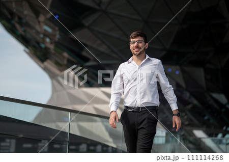 Good-looking young man in elegant outfit on urban background 111114268