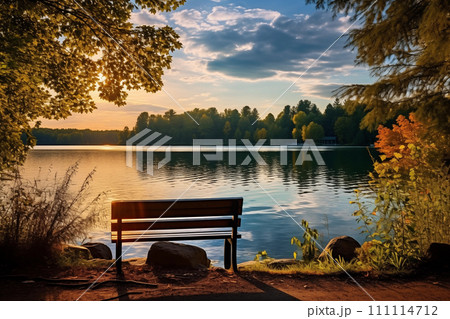 Bench on the shore of a lake at sunset in autumn, landscape 111114712
