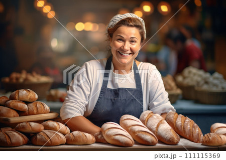 Baker woman in apron presenting a selection of freshly baked loaves at a market stall. Smiling middle-aged lady. Concept of small industries and healthy food 111115369