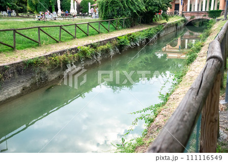 River crossing domestic park with terrace in residential areas of Bologna, Italy 111116549
