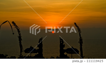 views of Penjor, Janur and Baliviews of Penjor, Janur and Balinese temples with a beautiful sunset in the backgroundnese temples with a beautiful sunset in the background 111119425