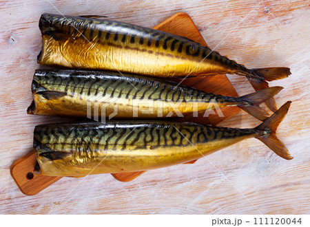 Smoked mackerel fish on wooden table Smoked mackerel fish on wooden table 111120044