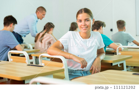 Portrait of smiling girl student looking at camera during lesson 111121202