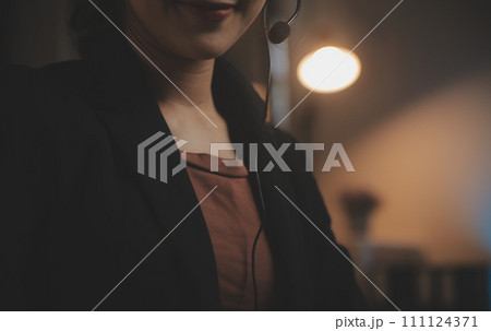 Young woman working in call centre, surrounded by colleagues Young woman working in call centre, surrounded by colleagues 111124371