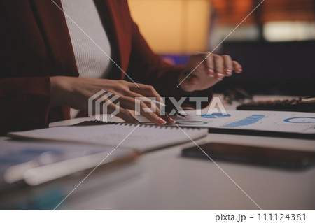 Business woman using calculator for do math finance on wooden desk in office and business working background, tax, accounting, statistics and analytic research concept Business woman using calculator for do math finance on wooden desk in office and business working background, tax, accounting, statistics and analytic research concept 111124381
