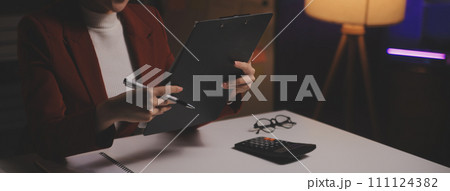 Business woman using calculator for do math finance on wooden desk in office and business working background, tax, accounting, statistics and analytic research concept Business woman using calculator for do math finance on wooden desk in office and business working background, tax, accounting, statistics and analytic research concept 111124382