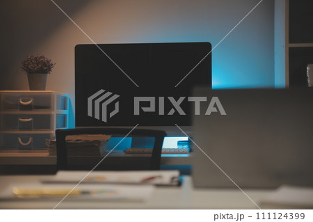 Laptop and paperwork on conference table 111124399