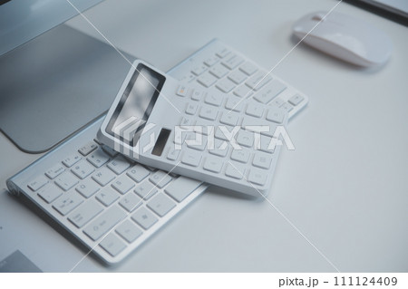 Laptop and paperwork on conference table Laptop and paperwork on conference table 111124409