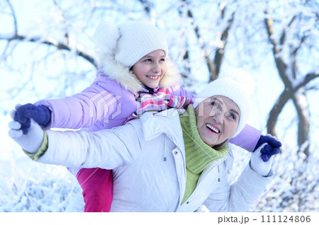 Portrait of grandmother and granddaughter in winter Portrait of grandmother and granddaughter in winter 111124806