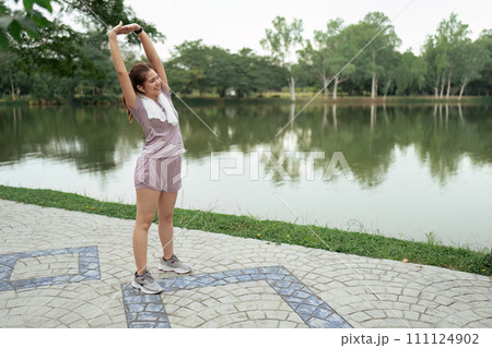 Woman in sport clothes stretch before going for running in the morning Woman in sport clothes stretch before going for running in the morning 111124902