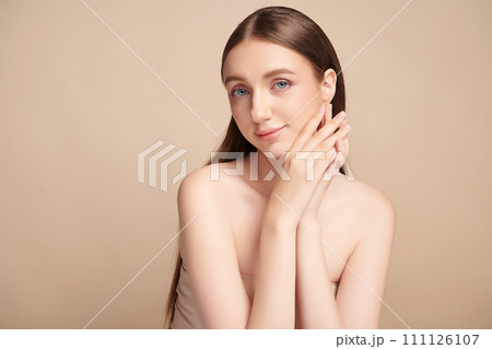 Beautiful young woman with clean fresh skin on beige background, Face care, Facial treatment, Cosmetology, beauty and spa, women portrait. 111126107