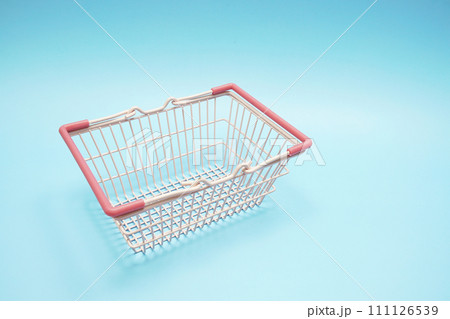 Pink empty shopping basket with space copy on blue background 111126539