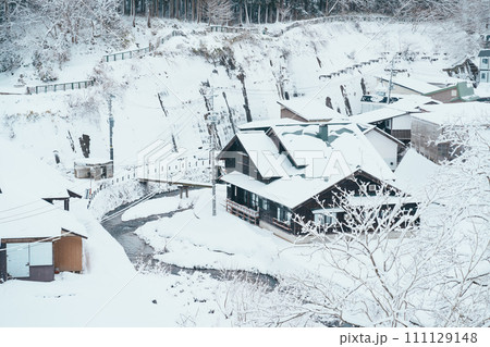 Beautiful view of Ginzan Onsen village with snow fall in winter season is most famous Japanese Hot Spring in Yamagata, Japan. Beautiful view of Ginzan Onsen village with snow fall in winter season is most famous Japanese Hot Spring in Yamagata, Japan. 111129148