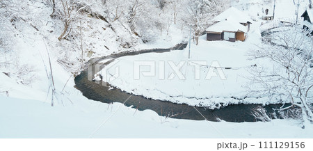 Beautiful view of Ginzan Onsen village with snow fall in winter season is most famous Japanese Hot Spring in Yamagata, Japan. Beautiful view of Ginzan Onsen village with snow fall in winter season is most famous Japanese Hot Spring in Yamagata, Japan. 111129156