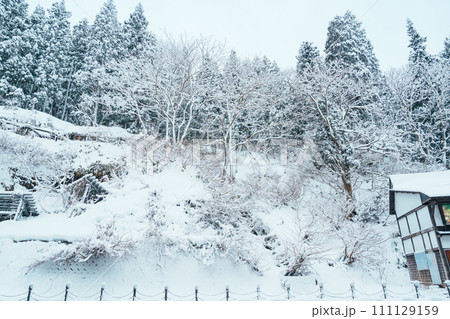 Beautiful view of Ginzan Onsen village with snow fall in winter season is most famous Japanese Hot Spring in Yamagata, Japan. 111129159