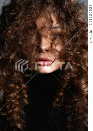 beautiful young woman with curly hair. beauty portrait 111129685