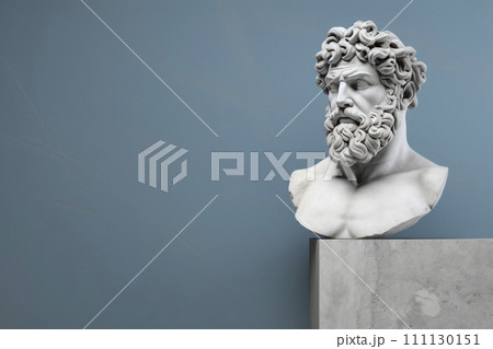 a bust of a Greek god made of stone on a pedestal. A sculpture of an ancient Roman man. 111130151