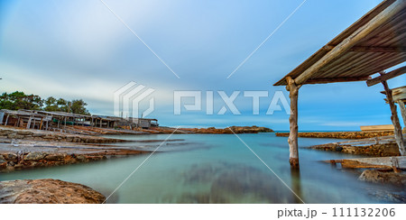 Long Exposure of Old Dock with Rails Leading to Clear Sea 111132206