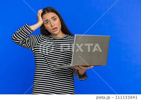 Displeased woman use laptop surprised by bad news, fortune loss, play game fail, lottery results 111133841