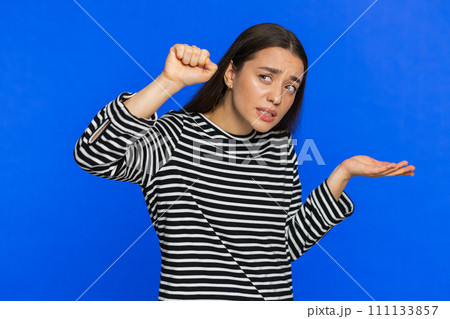 Confused Caucasian woman knocking door gesture asking who is at home feeling embarrassed no idea Confused Caucasian woman knocking door gesture asking who is at home feeling embarrassed no idea 111133857
