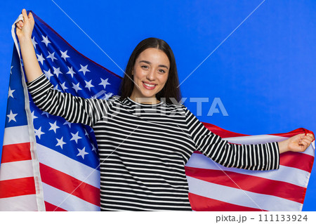 Caucasian young woman waving wrapping in American USA flag, celebrating, human rights and freedoms 111133924