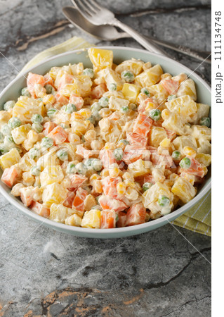 Brazilian gaucho potato salad brings together the best summer flavours from potatoes and grilled sweetcorn, to peas, carrots and apples closeup on the plate. Vertical Brazilian gaucho potato salad brings together the best summer flavours from potatoes and grilled sweetcorn, to peas, carrots and apples closeup on the plate. Vertical 111134748