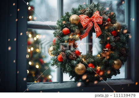 Christmas wreath with red bow, modern decor on house front or building facade. 111139479
