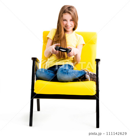 Pretty teen girl sitting, holding black joystick, playing console for computer games 111142629