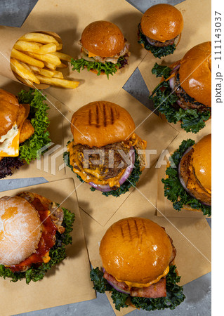 Big hamburgers and french fries on wooden table. Top view 111143037