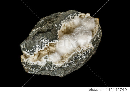 Macro stone Stilbite mineral on white black close up 111143740